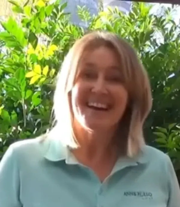 Anne Rollo outdoors in a green golf shirt.