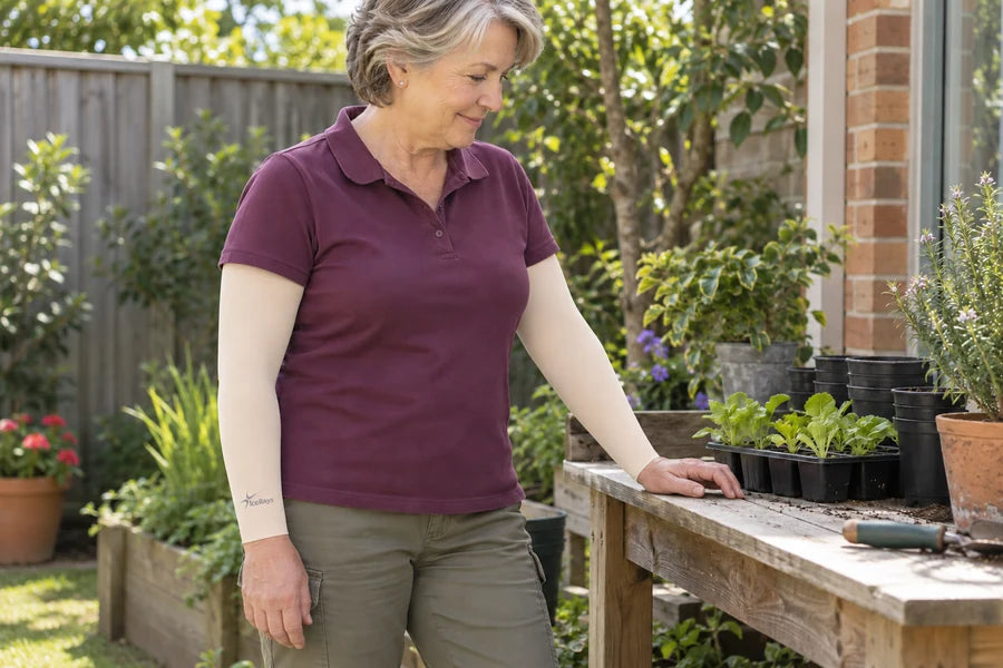 Woman wearing beige IceRays arm sleeves beside a potting bench.