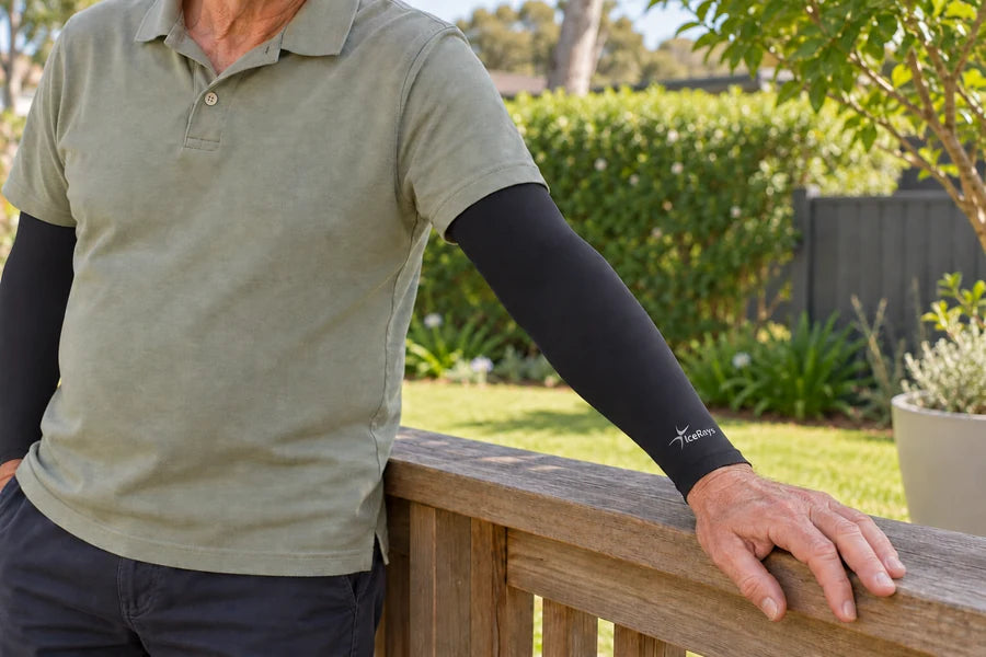 Close view of black IceRays arm sleeves with a hand resting on a timber rail.