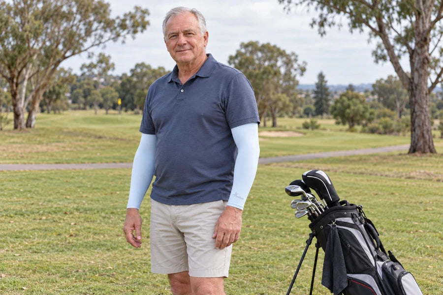 Man wearing light blue IceRays arm sleeves on a golf course.