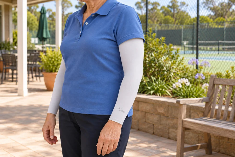 Light grey IceRays arm sleeves worn beneath a blue short-sleeved polo shirt.
